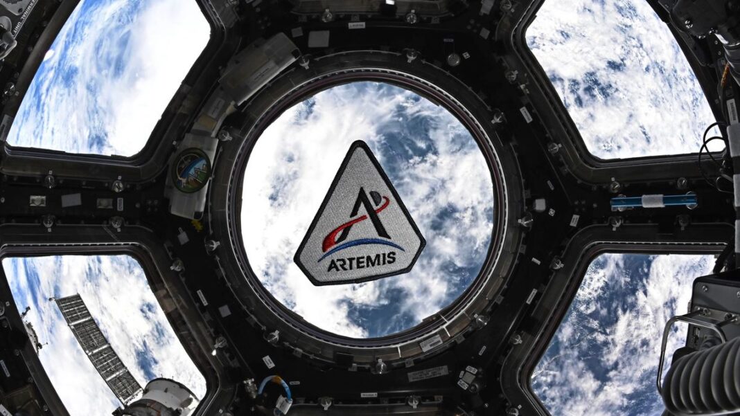 Ilustración de la nave Orión de la misión Artemis II en el espacio, con la Tierra de fondo.