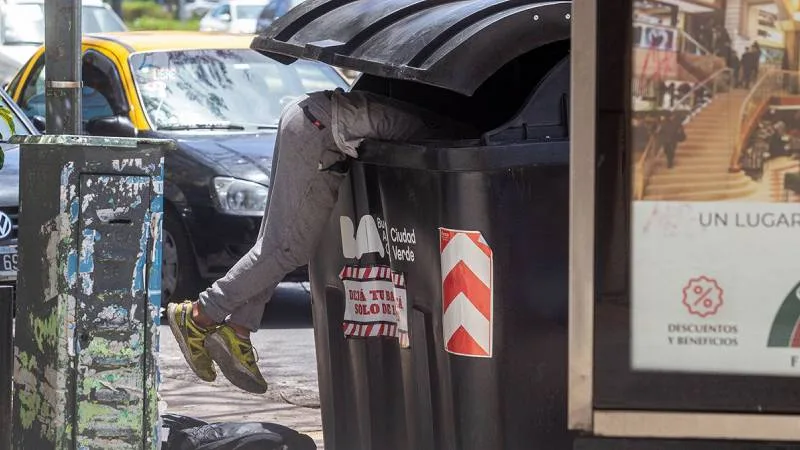 Gráfico de evolución de la pobreza y una familia revisando facturas de servicios.
