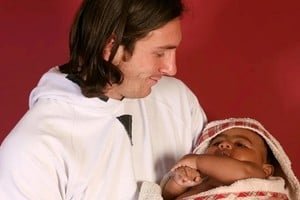 Lionel Messi sosteniendo a un bebé de seis meses durante una campaña solidaria en el Camp Nou en 2007
